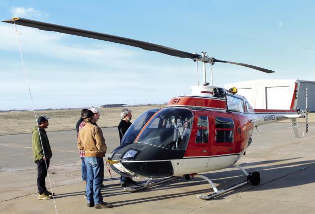 Students and instructors of the Gordon Cooper Technology Center Aviation program check out the recently purchased Bell TH-57 helicopter. Photo provided by GCTC