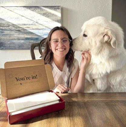 Shawnee graduate Chiara Carpenter celebrates her acceptance into the University of Oklahoma with support from her dog. Carpenter was in the Shawnee High School Class of 2023 that started high school during the COVID-19 pandemic and ended it with tornado damage to SHS. Photo provided.