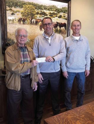 Bethel Superintendent Matt Posey accepts a $6,500 check from Pottawatomie County Facilities Authority Chairman Leonard Taron, left, and Vice-Chair Tom Wilsie at West Law Firm in Shawnee. Bethel Public Schools plans to use the money for signage on their campuses, including their new Upper Elementary. Photo provided.