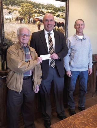 Tecumseh Superintendent Robert Kinsey accepts a $6,500 check from Pottawatomie County Facilities Authority Chairman Leonard Taron, left, and Vice-Chair Tom Wilsie at West Law Firm in Shawnee. Tecumseh Public Schools plans to use the funds to buy equipment, technology and supplies for their new Esports team. Photo provided.