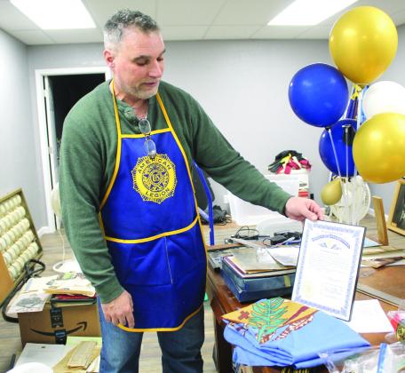 American Legion Post 16 Commander Keith DiPatri shows a state document about an Oklahoma flag that flew over the state capitol. They have several items in their collection, as well as photos, which need to be restored, organized and identified, and he is hoping for volunteers. The post reopened last September after being closed for 17 months due to the 2023 tornado. Countywide &amp;amp; Sun/Natasha Dunagan