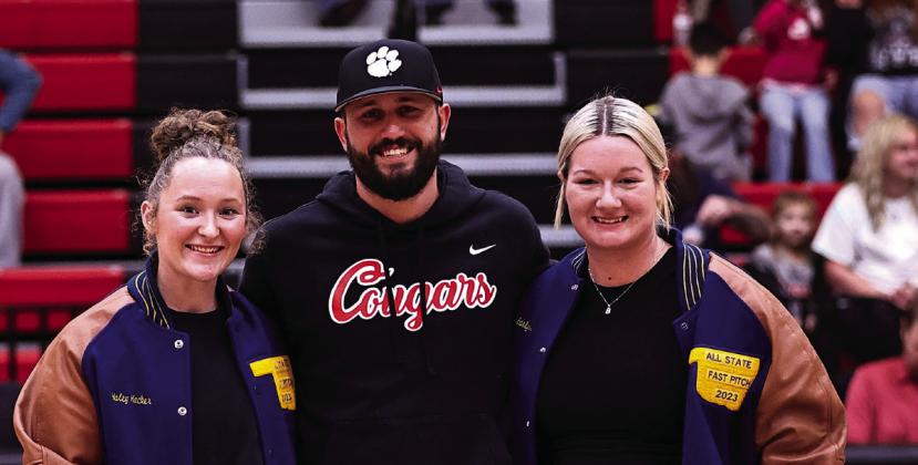 Above, North Rock Creek’s JJ McClain takes to the air to stop the Crooked Oak player from shooting the ball. Picture right, NRC Coach Griffith presents All-State Fast Pitch jackets to Haley Hacker and Hannah Earlywine.