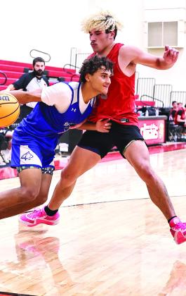 North Rock Creek’s JJ McClain stops the Bridge Creek player from driving to the basket.