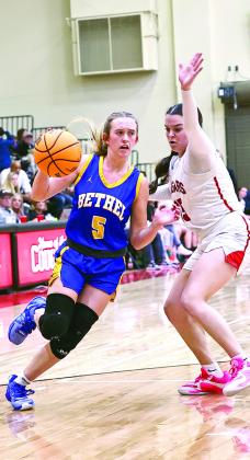 Bethel High Schools Brooklyn Duff drives to the basket past Morgan Campbell. Photo courtesy of Gowin Photography
