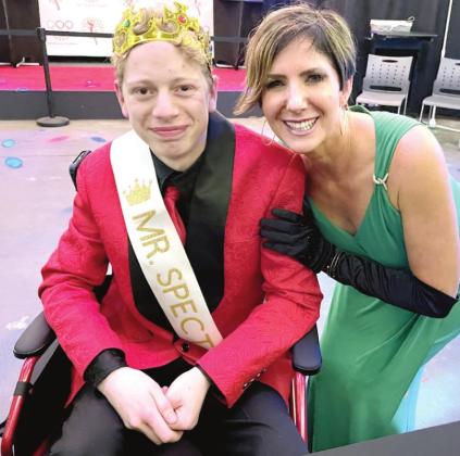 SCI Executive Director Tina Hanna congratulates Ian Brown who was crowned as Mr. Spectacular at the first pageant. Photo provided