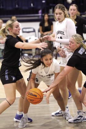 Shawnee junior Aniya Kowena defends the ball from two Guthrie players in the fourth quarter of the Dec. 17 home game. The Lady Wolves triumphed, 68-20, and the Wolves would also find victory, 77-44. Countywide &amp; Sun/Natasha Dunagan