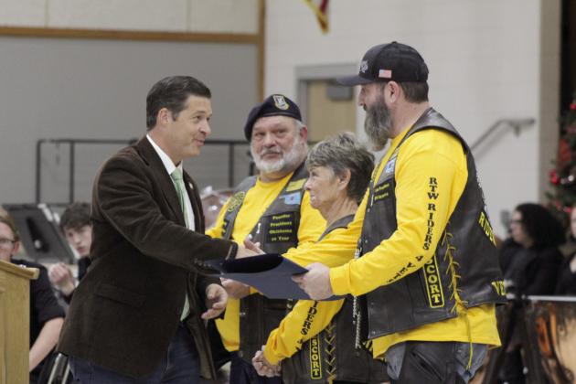 Oklahoma State Senator Shane Jett presents Citations of Commemoration to Cory “Shockwave” Stephens, the VP of Roll to Wreaths Riders 4 Vets Riding Club, far right; as well as, Club President Ralph “Rowdy” Butler and Marie “Mama Ree” Butler for their service to veterans at the National Wreaths Across America Day event in Tecumseh, Dec. 16. Countywide &amp; Sun/Natasha Dunagan