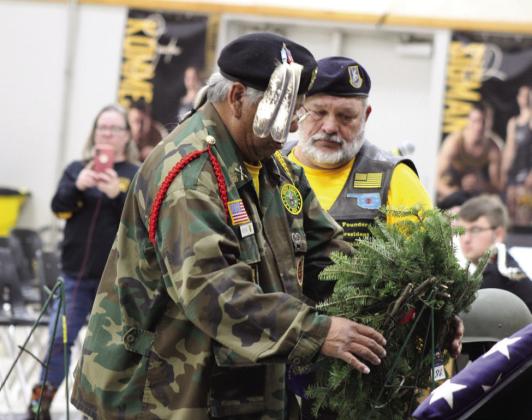 Army Veteran and Seminole Nation Honor Guard member Alex Fish places a wreath, as Roll to Wreaths Riders 4 Vets founder Ralph “Rowdy” Butler looks on, during the National Wreaths Across America ceremony at the W.P. Wood/THS Alumni Center on Dec. 16.