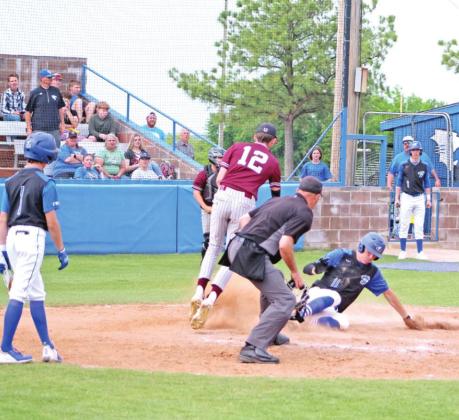 Bronc Robbins steals home with a slide.