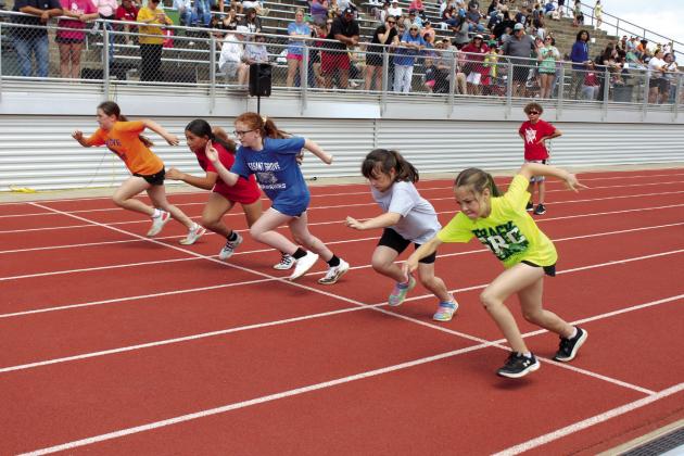 Sixth-grade girls from Grove, North Rock Creek, Pleasant Grove, Liberty and South Rock Creek take off from the starting line in the Division Two 50-yard dash during the Kiwanis Little Olympics, held at Jim Thorpe Stadium in Shawnee on May 3.