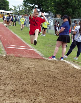 North Rock Creek sixth-grader Harper Fuller flies over the dirt in the long jump.