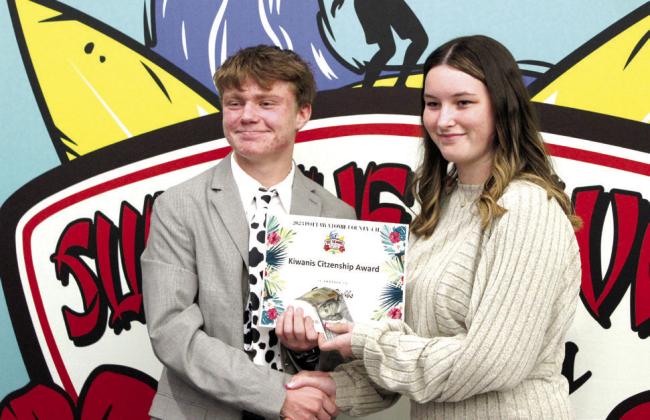 Grace Hobbs receives the Kiwanis Outstanding Citizenship Award from 4-H Vice President Taylor Marrs, who later received the same award, during the county 4-H Awards Banquet, held at the North Rock Creek High School Cafeteria on Oct. 23.