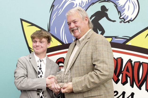 Randy Gilbert, right, accepts the Pottawatomie County 4-H 2023 Lifetime Volunteer of the Year Award from 4-H Vice President Taylor Marrs during the county 4-H Awards Banquet, held at the North Rock Creek High School Cafeteria.