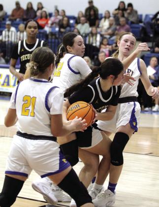 Tecumseh’s Peyton Bays grabs the rebound and is blocked by three Bethel defenders during the Bethel First United Tournament Consolation on Dec. 14. The Lady Savages lost to Eufaula, 27-33; won with Perkins-Tryon, 41-39; and fell to Bethel, 35-43. Countywide &amp; Sun/Natasha Dunagan