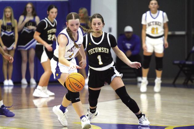 Tecumseh’s Cadence Leba and Bethel’s Kinley Bowles keep their eyes on the ball during the Bethel First United Tournament Consolation Championship on Dec. 14.