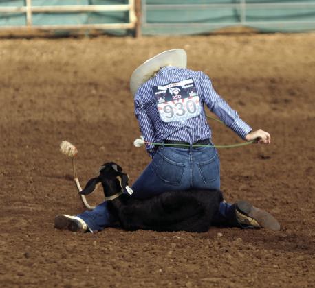Rianne Tinsley of Bethel pulls a rope from her belt loops to tie her goat during the International Finals Youth Rodeo on July 16.