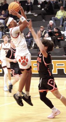 Maud freshman Koi Street aims for the basket during the Dec. 4 game against Alex in the Maud 8-Man Basketball Tournament. The Tigers hosted seven other teams in the three-day girls' and boys' tournament. They lost to Alex, 35-42; won against Fox, 65-35; and fell to Life Christian Academy, 60-37.