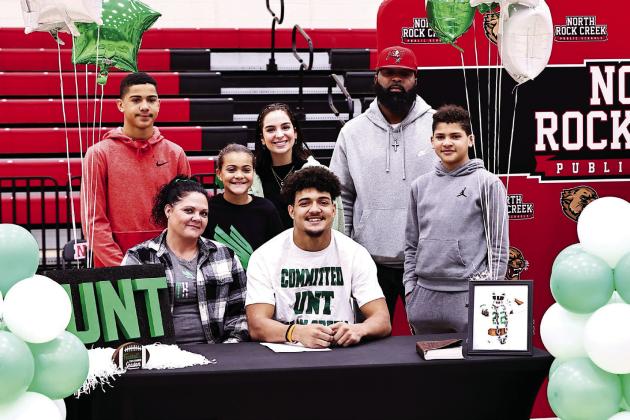 North Rock Creek’s Caleb Hawkins signed to play football with North Texas State University. He is the first NRC player to sign to play Division 1 football. Caleb is pictured with his mom Krista, and back row, from left: brother, Tyson; sister, Raevynn; Avery Barnett; dad, Adam and brother, Ace.
