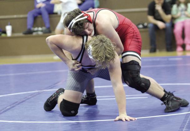 McLoud’s Peyton Smith grapples with Bethel’s Kaiden Wiens in the 190 weight class.