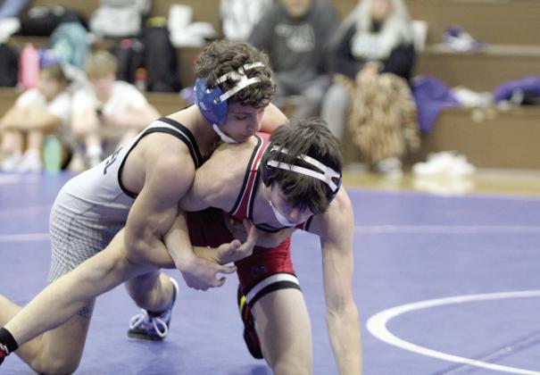 In the 120 weight class, Bethel’s Paxton Schultz tries to take down McLoud’s Tripp Bishop.