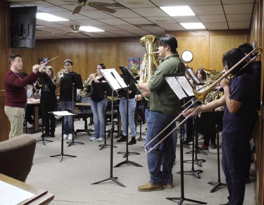 Shawnee High School Assistant Director of Bands Jackson Anderson conducts the 17-piece Jazz Band in “Carol of the Bells” during the Shawnee Board of Education meeting on Dec. 5. Countywide &amp;amp; Sun/ Natasha Dunagan