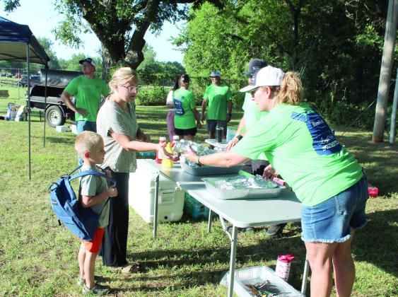 Tecumseh BancFirst Branch Manager Rebecca Foreman gives away free hotdogs.