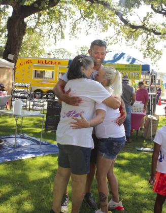 Alexis McCool, left, of McLoud, her son, Arthur McCool, and daughter-in-law Rita Beal, both of Shawnee, have a group "Forever Hug" during the First Annual Hug-A-Thon held at Woodland Veterans Park on Aug. 3. Alexis said that getting Forever Hugs for the family was Rita's idea. Countywide &amp; Sun/Natasha Dunagan