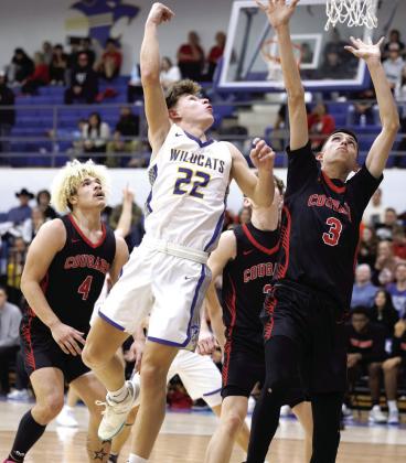 Bethel sophomore Maddox Davis throws up a hook shot during the Jan. 17 homecoming game against North Rock Creek. On NRC defense are senior J.J. McClain, Jr. (#4) and senior Cason Coomer (#3). The Wildcats lost 30-59.