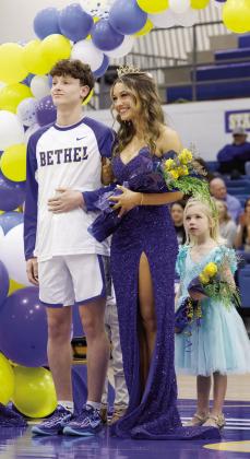 The Bethel High School Basketball Homecoming Queen, senior Kinsley Clanin, poses with Darius Cheatham, as flower girl Maven Freeman watches, during the ceremony on Jan. 17.