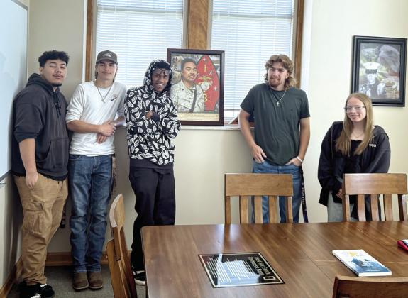 Earlsboro students pause from their County Buildings Tour to pose with a photo of HN (FMF) Eric D. Warren, the son of one of their teachers. Warren passed away on May 26, 2012, while serving in Afghanistan; he was 23 years old. Photos by Julie Talton, Countywide &amp; Sun