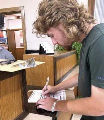 Jonathan Wilkins registers to vote during the High School County Buildings Tour on April 27.