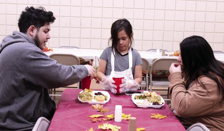 Madisyn Castaneda, 10, serves drinks to Jimmy and Unity Alas of Maud during the 20th Anniversary Tecumseh Family Thanksgiving Dinner, held at the Tecumseh City Hall Auditorium on Nov. 27. U. Alas said she used to come to the dinner with her father and grandmother, and decided to introduce her husband to it this year. Castaneda was volunteering for the first time with her two sisters and her parents, Daniel and Amber Castaneda. Natasha Dunagan, Countywide &amp; Sun