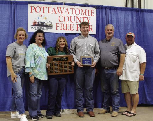 Gus Goodson, of North Rock Creek FFA, was named this year's recipient of the Ann "Sis" Gilbert Memorial Award at the Pottawatomie County Free Fair Awards. He received a plaque, $100, and his name on the traveling plaque, held by last year's winner Poppy Robinson. Also shown are his mother, Lindsay Goodson, Suzanne Gilbert, Robinson, Goodson, Randy Gilbert and Goodson's father, Josh Goodson. Countywide &amp; Sun/Natasha Dunagan