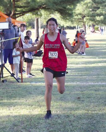 Earlsboro freshman Ana Roubidoux crosses the finish line in sixth place for the High School Girls Two-Mile division of the Tecumseh Savage Cross Country Invitational on Sept. 26. According to ohstrack. com, Roubidoux’s time girls team placed second. In addition to Earlsboro and Tecumseh, New Lima and Lexington participated in the evening event. Countywide &amp;amp; Sun/ Natasha Dunagan