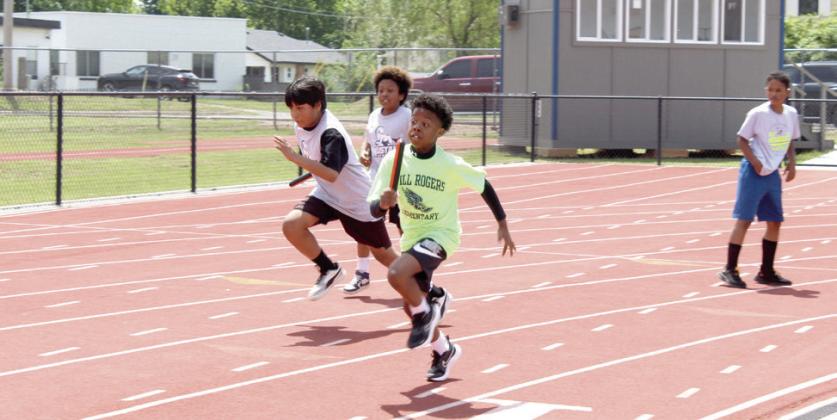 Will Rogers Elementary fourth-grade student, Aiyden Rutledge, in foreground, runs in the Division 1 4x100-meter relay. Students in fourth through sixth grade competed in track and field competitions. Division I includes Will Rogers, Horace Mann, Sequoyah and Jefferson elementary schools.