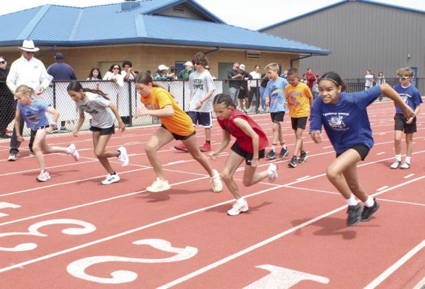 Shawnee sixth-grade girls from area independent elementary schools take off from the starting line in the Division II 100-meter dash during Kiwanis Little Olympics, held at Jim Thorpe Stadium on May 1.