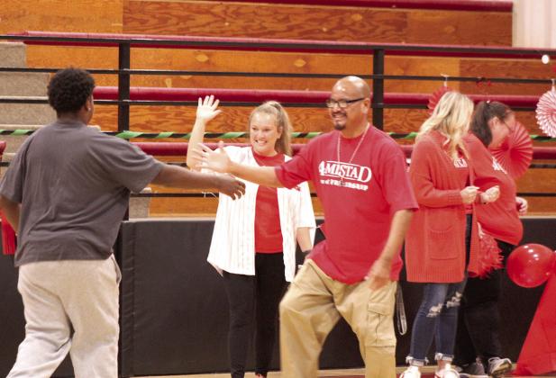 Earlsboro High School student Steven Winn gets high fives from school staff members Chris McKinney and Amanda Elmore after joining the Amistad House during the Sorting Ceremony on Sept. 2. In the past, Earlsboro held a sorting ceremony for the elementary students, but this year, it includes all of their students and follows the Ron Clark Academy. Natasha Dunagan, Countywide &amp;amp; Sun