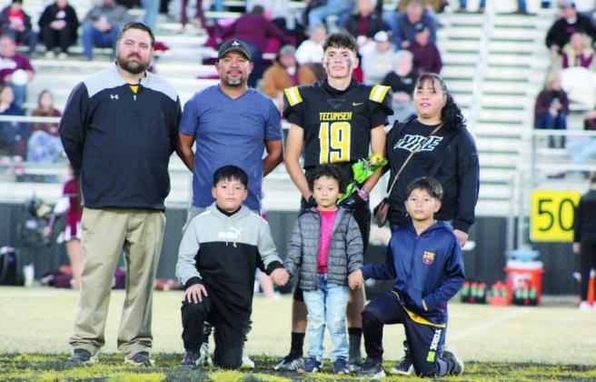Tecumseh Head Football Coach Ty Bullock poses with Aden Boone and his family during THS Senior Night ceremonies before the home game on Nov. 3. There were 14 football seniors and three managers honored that evening, as well as band and cheer seniors. Countywide &amp;amp; Sun/Natasha Dunagan