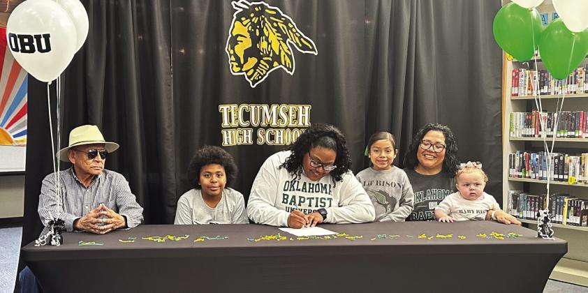 Tecumseh senior Kiara Stallin, center, signed a letter of intent with Oklahoma Baptist University for track on March 5. Stallin is shown with her family, from left, Tommy Kaskaske, Keelym Parks, Aniyah Masquas, Fallon Jackson and Makayla Allen. Photo provided by Casi Bays.