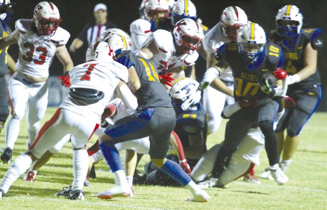 Bethel junior Luke Quinter (#10) carries the ball as a Kiefer defender tries to take him down. Quinter ran the ball for four plays on his way to a touchdown before halftime. The Wildcats lost, 20-30.