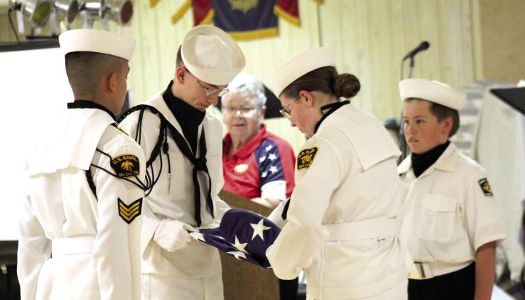 The Naval Sea Cadet Color Guard demonstrattes the folding of the U.S. flag, as Sea Cadet Director Donna Snodgrass reads their meanings during the Tecumseh American Legion Post #260 Flag Day Ceremony on June 14. The Color Guard is, from left, Kenneth Irwin, Zachary Hastings, Diana Murray and Daryl Murray. Natasha Dunagan, Countywide &amp;amp; Sun