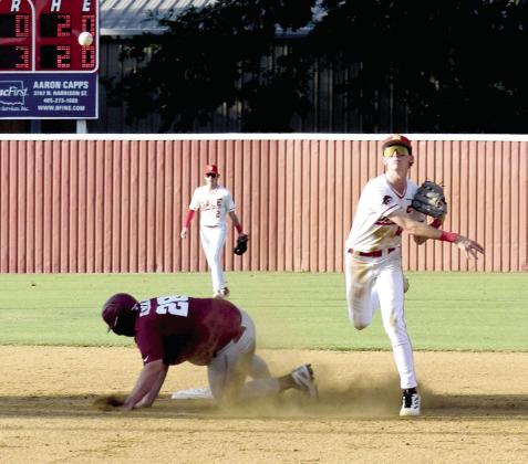 Chase Harris tags the runner out at second then throws the ball to first. Julie Talton, Countywide &amp;amp; Sun