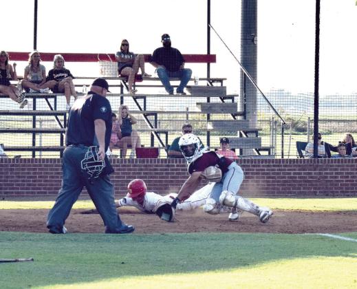 Dale's Andrew Collins slides across home plate ahead of the ball to score for the Pirates.