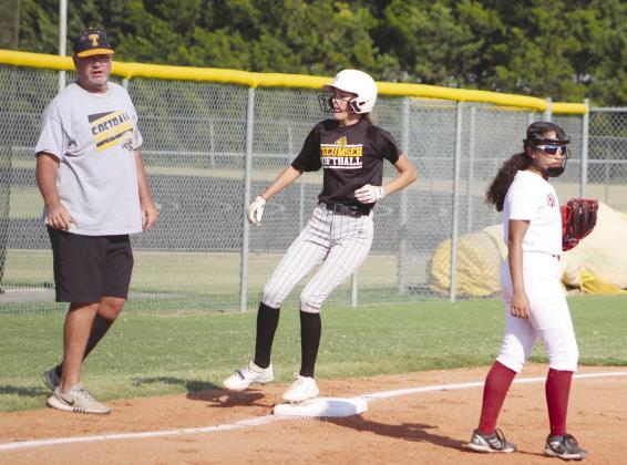 Tecumseh freshman Haley Mansell lands on third after hitting a triple in second inning of the Aug. 22 game with Holland Hall. Also shown is Head Fastpitch Coach Chad Trahan. Countywide &amp; Sun/Natasha Dunagan