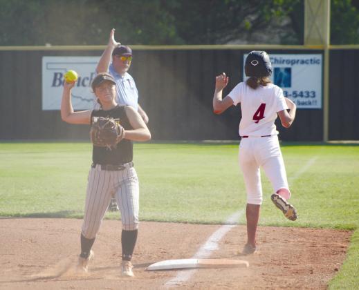 Tecumseh junior Jessi Hull throws to a teammate after getting the Holland Hall runner out at first on Aug. 22. Countywide &amp; Sun/Natasha Dunagan