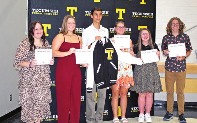 Tecumseh students, from left, Jaycee Barham, Emily Bingham, Logan Haworth, Tara Lack, Ella Whitney, and Izak Williams accept their THS Scholar Awards during the Academic Awards Reception on May 3. However, due to a factory fire where the jackets are made, they were not able to receive their letter jackets yet. Piper Goodson is not shown.