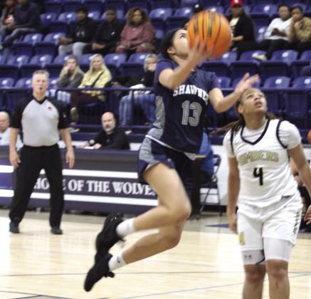 Shawnee freshman Eliana Shields sails toward the basket and sinks her shot in the Jan. 22 game against Midwest City. Natasha Dunagan, Countywide &amp; Sun
