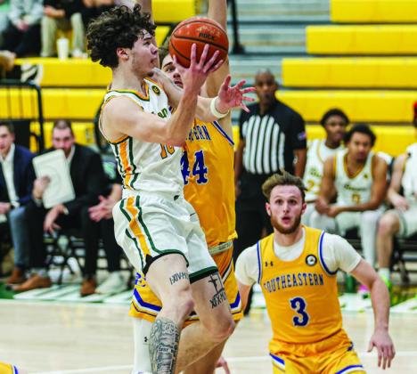 Oklahoma Baptist University’s JC Curry goes for the shot among three Harding defensive players in the win Saturday, Jan. 11. The Bison take on Ouachita in a home game tonight (Thursday, Jan. 16). Tipoff is scheduled for 7:30 pm. Photo provided by OBU