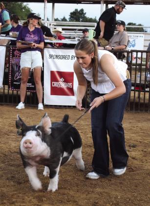 Baylee Weeks of Meeker shows her Berkshire swine. Meeks won Class One and Grand Champion Berkshire. Her grandmother, Jerry Jones, lives in Tecumseh.