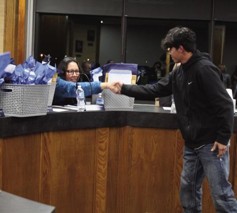 Jim Thorpe Academy graduate Elijah Kaniatobe shankes hands with Shawnee school board member Kristen Wilson for School Board Appreciation Month during the meeting on Jan. 6. Countywide &amp; Sun/Natasha Dunagan